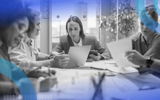 Team of executives brainstorming while reviewing documents