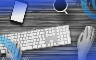 This image shows the hands of a person using a keyboard and a mouse.