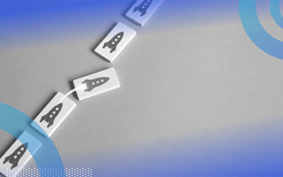 Five domino-shaped rectangles lined up with rocketships printed on them. The middle rocketship rectangle is taking off toward the right, out of the line.