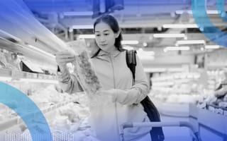 The 8 Consumer Archetypes A woman grocery shopping, looking closely at sustainbly packaged vegetables.