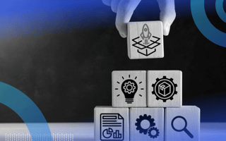 A hand stacking blocks with images representing the different stages of product development, the top block having a rocket launching out of a box on it.