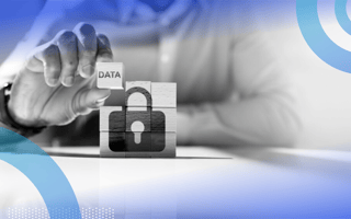 A shoulders-down view of someone stacking blocks in a square. The blocks form the image of a lock, with one block reading, “data.”