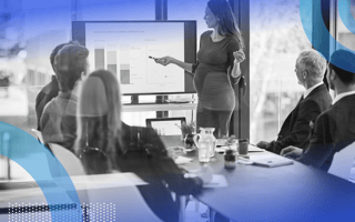 A pregnant woman gives a presentation in a corporate office