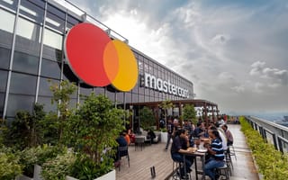 An exterior photo of a building in Pune, India featuring the Mastercard logo.