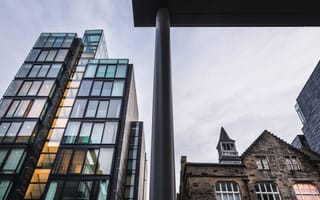 Modern building next to old building in Edinburgh, Scotland.