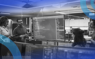 Technical writers working with product huddled around screen
