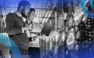 6 Ways AI Can Supercharge IT Service Management Two IT specialists looking at a laptop while pointing at holographic images representing AI and cloud computing.