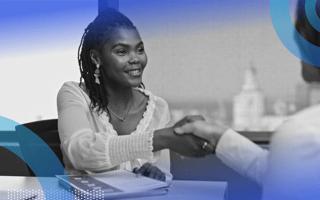 A candidate shaking hands with her interviewer.