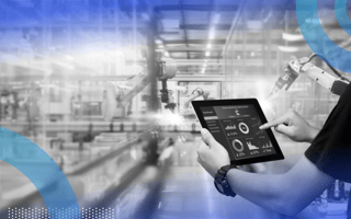 A construction worker using an iPad with controls and graphs on it to control a robot.