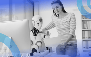 A woman shows a page of text to a robotic collaborator in front of a desktop terminal