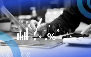 Closeup on hands working on a tablet with graphs and a percentage icon