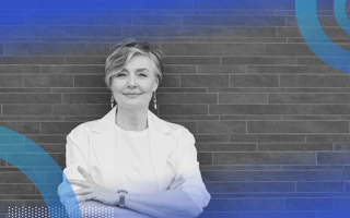 A woman stands with her arms crossed