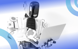 A big robot is holding a laptop.
