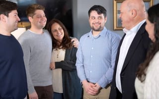 The Rice family smiles at one another in the Energy CX office.