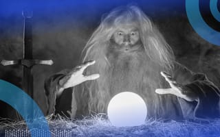 An old man wizard with long white hair and a long white beard gazing into a glowing crystal ball before him.