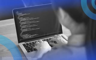 Developer reviewing HTML code on laptop