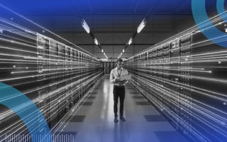 A tech worker stands between servers