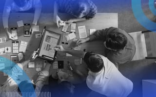 A group of software developers working at a table.