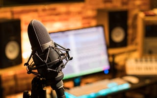 A microphone in front of a computer is pictured.