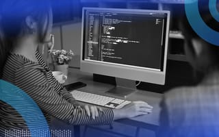 Two developeres reviewing Python code on desktop