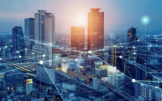 The concept of a wireless network depicted as white lines that are interconnected and stretching across a city, moving in between skyscrapers and hovering above streets.