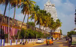 Cars drive on the street in Tiruchirappalli, also known as Trichy.