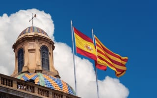 Catalunyan and Spanish flags in front of Palau de la generalitat de Catalunya in Barcelona, Spain.