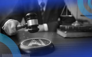 A hand holds a gavel above an AI symbol