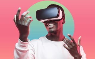 A man wearing a VR headset, holding his hands out.