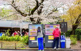 Two people using a vending machine in Tokyo, Japan.