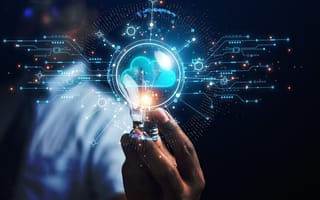 An image of a hand reaching toward a digital illustration of a cloud to depict cloud technology.