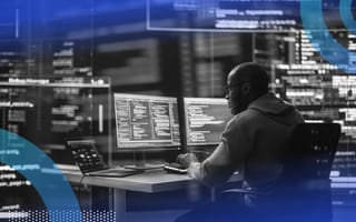 A developer sits at a terminal full of code