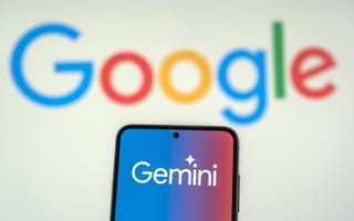 A smartphone with Gemini pulled up on its screen, and the Google logo is in the background