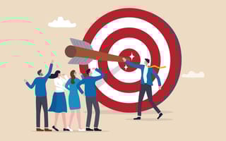 Illustration of professionals standing next to a giant bulls-eye board with a dart stuck in the middle, symbolizing the idea of employees working together to hit business goals