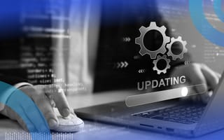 A user works on a laptop that is updating