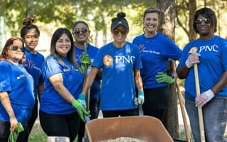 PNC team members pose for a group photo while volunteering together