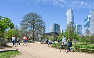 People enjoy a walk during spring at Auditorium Shores in Town Lake Metropolitan Park
