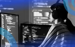 developer writing C# code with multiple monitors