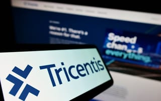 The image shows a clear logo of "Tricentis" on a screen, with a blurred background displaying the website.