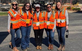 Caterpillar team members pose for a group as part of a Woman in Construction group