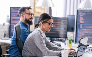 man and women working at computers