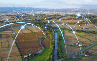 A series of digital arcs connect fields and farms, representing next-gen technologies in agriculture.