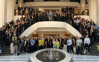 Kustomer team members posing for a large group photo on front steps of conference center