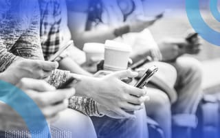 people on a bench watching digital content on their phones