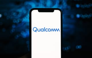 Smartphone displaying the Qualcomm logo on a white screen, set against a blurred blue background, creating a tech-focused, modern vibe.