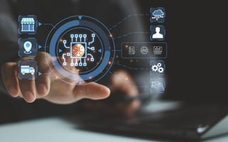 A hand interacts with a digital interface displaying a central microchip icon surrounded by digital symbols for logistics, cloud and automation.