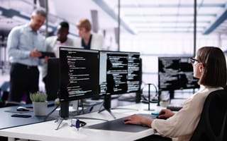 Software Engineer Developer Using Desktop Computer. Coding On PC with multiple monitors