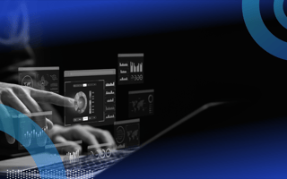 A systems analyst works on a laptop