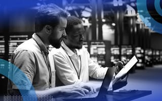 Two developers reviewing code in a hardware facility