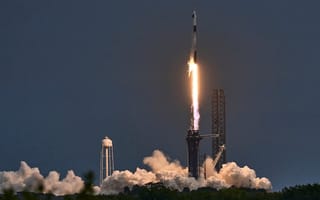 SpaceX Falcon 9 Axiom Mission 3 Ax-3 pictured in liftoff with a wide detail of an exhaust cloud below.